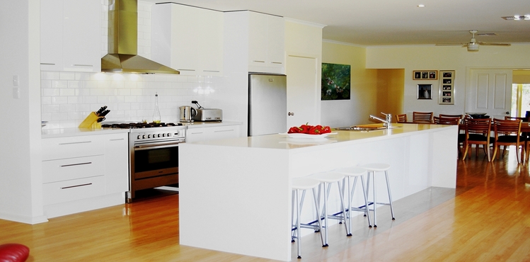 A White on White Kitchen Renovation at Victor Harbor, with a Long 4.2mt Island, Gloss Two Pack Doors and Reconstituted Stone Benchtops by Compass Kitchens of Adelaide